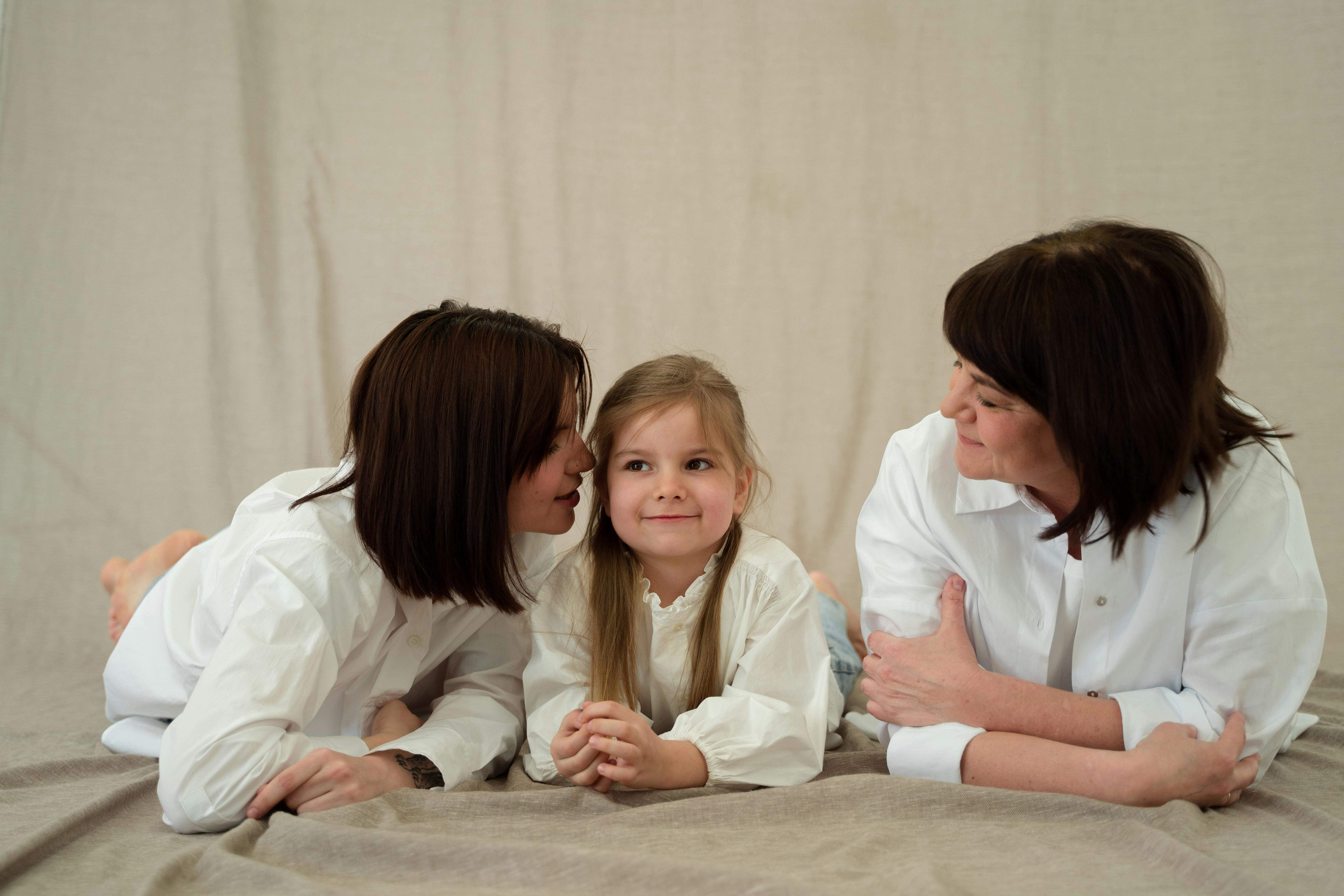 Three generations of women smiling together, symbolizing familial love and connection.